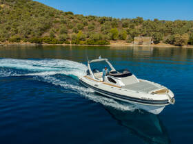 A sleek speedboat navigates through calm waters, showcasing its design and performance against a picturesque backdrop of lush greenery.