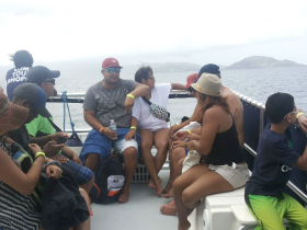 A lively group enjoys their time aboard a boat, showcasing the fun and camaraderie of a family outing on the water.