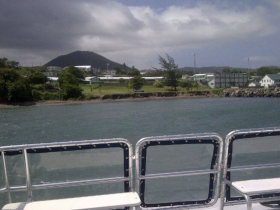 A scenic view from the deck of a boat, showcasing the shoreline and surrounding landscape, perfect for capturing the essence of a coastal adventure.