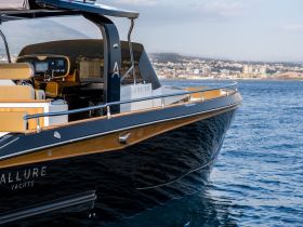 A stunning view of the Allure 38 yacht, showcasing its sleek design and luxurious features against a picturesque coastal backdrop.