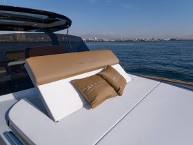 A stylish lounge area on a yacht featuring plush cushions, perfect for relaxation while enjoying the open water.