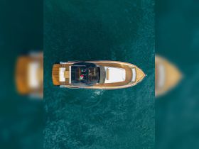 Aerial view of a sleek boat gliding through crystal-clear waters, showcasing its elegant design and perfect for luxury outings.