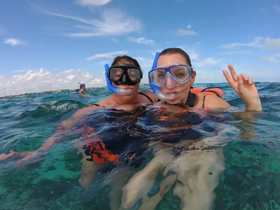 Two friends enjoy snorkeling in clear waters, capturing a fun moment while exploring underwater life — perfect for adventure seekers and water enthusiasts.