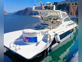 A stunning view of the 'Oasi' boat docked in serene waters, showcasing its sleek design and inviting seating area — perfect for leisurely outings.