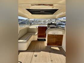 A spacious and inviting interior view of a boat's helm and seating area, showcasing a comfortable cabin setup perfect for relaxation and navigation.