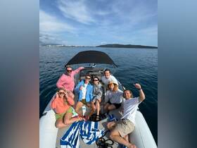A cheerful group of friends poses for a fun photo on a boat, enjoying a sunny day on the water — perfect for memorable outings and celebrations.
