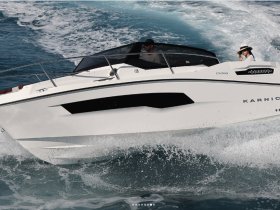 A sleek speedboat cuts through the waves, showcasing an exhilarating ride on the water with guests enjoying the experience.