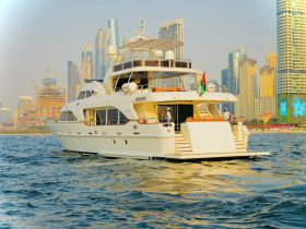 A luxurious yacht cruising in front of a stunning city skyline, showcasing the perfect blend of modern architecture and maritime elegance.