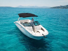 A stunning aerial view of a sleek speedboat cruising through crystal-clear turquoise waters, perfect for summer adventures on the sea.
