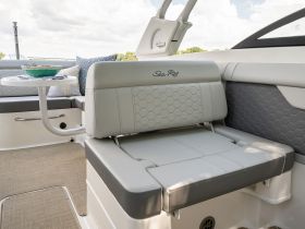 A stylish interior view of a Sea Ray boat showcasing comfortable seating and a cozy atmosphere, perfect for relaxing on the water.