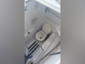 Interior view of a boat's bathroom featuring a toilet, designed for convenience on the water. Ideal for ensuring comfort during trips.