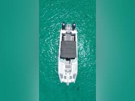 Aerial view of a sleek boat anchored in crystal-clear turquoise waters, showcasing its elegant design and spacious deck — perfect for a day on the water.