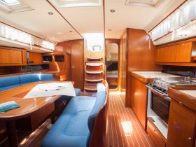 Interior view of a cozy boat cabin featuring a dining area and seating, perfect for relaxing and enjoying meals while at sea.