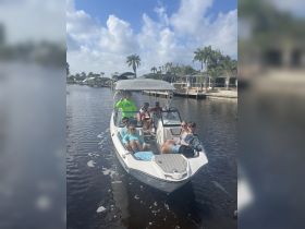 A lively group enjoys a day on the water aboard a boat, showcasing the perfect atmosphere for fun and relaxation with friends.