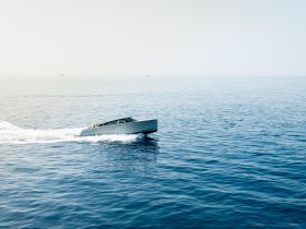 A sleek speedboat glides through calm waters, showcasing its elegant design and performance — perfect for thrilling adventures on the open sea.