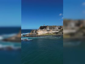 A stunning aerial view of a historic coastal fortress, surrounded by turquoise waters and rocky shores, showcasing the beauty of the landscape.