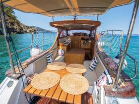 A beautifully designed interior of a boat featuring a cozy seating area and helm, perfect for relaxing while enjoying the scenic views of the water.