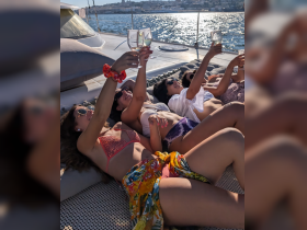 A group of friends enjoys a sunny day on a yacht, raising their glasses in celebration — perfect for memorable gatherings and summer parties on the water.