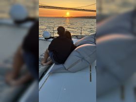 A couple enjoys a romantic sunset view from the deck of a yacht, creating the perfect atmosphere for special moments on the water.