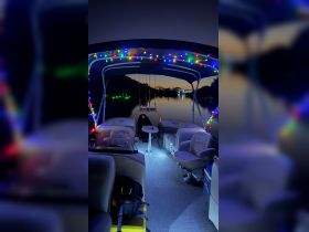 A cozy interior view of a boat adorned with colorful lights, perfect for nighttime outings on the water.