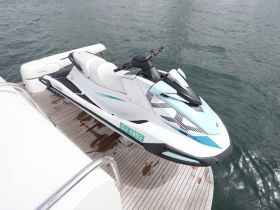 A sleek Yamaha jet ski is docked on a luxurious boat, ready for thrilling water adventures. Ideal for those seeking excitement on the waves.