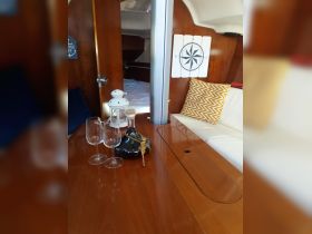 An inviting interior view of a boat cabin featuring a cozy seating area and dining setup, perfect for relaxing and enjoying meals while on the water.