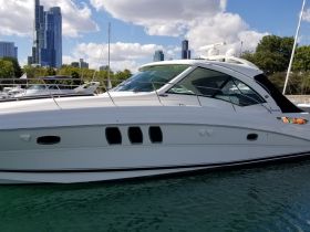 A sleek yacht docked with a stunning city skyline in the background, showcasing its elegant design and perfect for luxury outings on the water.