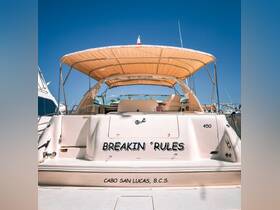 A stunning view of the back of the yacht 'Breakin' Rules' docked in Cabo San Lucas, showcasing its elegant design and inviting atmosphere.