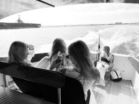 A group of friends relaxes on a boat, enjoying drinks and the scenic views — perfect for a fun day on the water.
