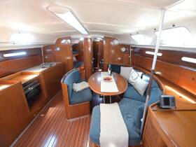 Interior view of a cozy boat cabin featuring a dining area and well-equipped kitchen, perfect for relaxing and dining while at sea.