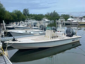 A sleek boat docked at a marina, surrounded by other vessels, showcasing the perfect setting for a day on the water.