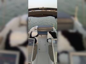 Interior view of a boat's seating area featuring cozy cushions, perfect for relaxing while enjoying a day on the water.