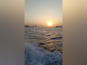 A stunning sunset over the water, showcasing the beautiful skyline and coastline — perfect for romantic evening cruises or scenic boat trips.