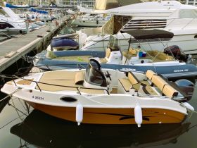 A sleek boat named 'Elegance' docked at a marina, showcasing its stylish design and comfortable seating — perfect for leisurely outings on the water.