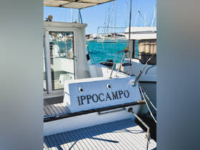 A close-up view of the 'Ippocampo' boat docked in a marina, showcasing its sleek design and inviting atmosphere against a backdrop of other vessels.