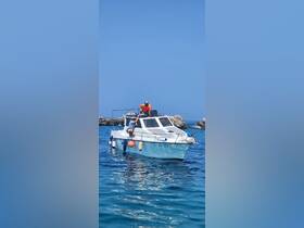 Two individuals aboard a boat enjoy a sunny day on the water, showcasing a perfect moment for marine adventures.