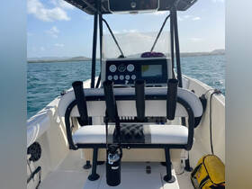 A well-equipped helm area of a boat featuring seating and control panels, perfect for navigating the open waters.