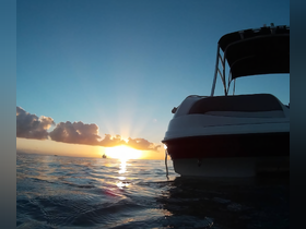 A serene sunset view featuring a boat silhouetted against the vibrant sky, perfect for showcasing tranquil boating experiences.