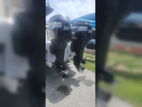 Close-up view of two powerful Mercury 200 HP outboard motors, showcasing essential boating equipment for high-performance vessels.