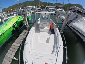An interior view of a boat's helm and seating area, showcasing the spacious layout and comfortable design, perfect for a day on the water.