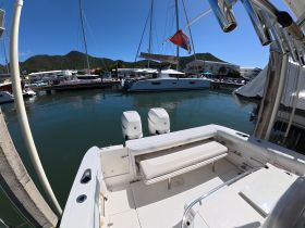 A view of the interior seating area of a boat, showcasing a clean and spacious helm area, perfect for relaxing or navigating on the water.