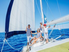 A joyful family enjoys a sailing adventure on a catamaran, capturing the essence of fun and togetherness on the open water.