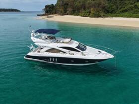 A stunning aerial view of a luxurious yacht anchored in crystal-clear waters, perfect for a serene getaway or island exploration.