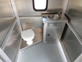 Interior view of a boat bathroom featuring a toilet and sink, designed for convenience on the water.