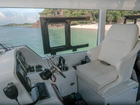 A well-equipped helm area inside a boat, featuring a comfortable captain's chair and navigational controls, perfect for steering through beautiful waters.