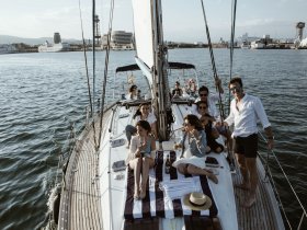 A lively group enjoys a day on a yacht, celebrating with cocktails and laughter — perfect for unforgettable gatherings on the water.