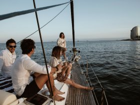 A group of friends enjoys cocktails on a yacht, capturing the essence of a perfect sunset cruise — ideal for celebrations and memorable moments on the water.