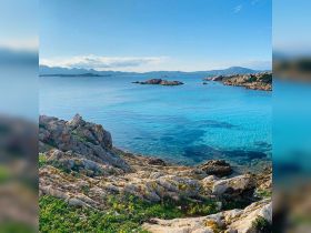 A stunning view of turquoise waters and rocky coastline, perfect for showcasing the natural beauty of island destinations.