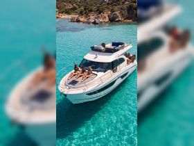 A group of friends enjoys sunbathing on the deck of a luxurious yacht in crystal-clear turquoise waters, perfect for summer getaways and relaxation.