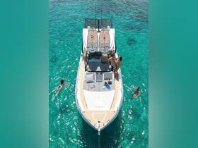 A couple enjoys a sunny day on a boat surrounded by crystal-clear turquoise waters, with one person swimming nearby — a perfect scene for water activities and relaxation.
